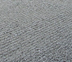 Close-up of gray textured surface with fine diagonal ridges and a granular, grainy finish