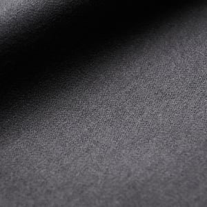 Close-up of dark grey woolen flannel fabric with a fine woven texture and soft shadows