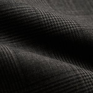 Close-up of dark charcoal grey wool fabric with a subtle check pattern and soft folds