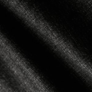 Close-up of dark charcoal grey flannel wool fabric with a soft, finely woven texture and gentle folds