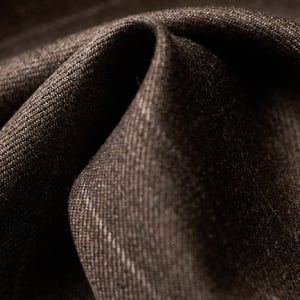 Close-up of dark brown wool fabric with a twill weave and faint light pinstripes, softly folded