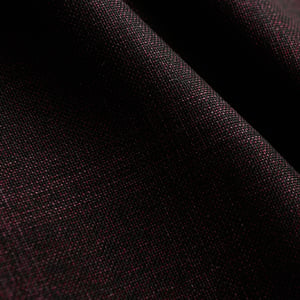 Close-up of dark burgundy-black woolen fabric with a fine woven texture, draped in soft folds