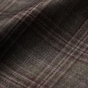 Close-up of dark grey wool fabric with a subtle burgundy and light check pattern, softly draped