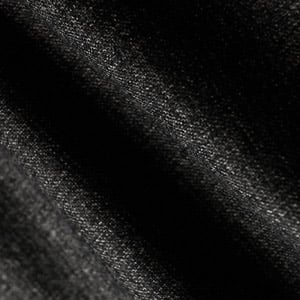 Close-up of dark charcoal woolen fabric with soft folds and a fine diagonal weave texture