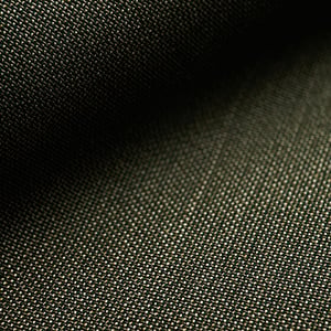 Close-up of dark olive-green woven wool fabric with a fine texture, softly shaded on one side