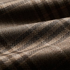 Close-up of brown woolen fabric with a subtle tonal check pattern and soft folds