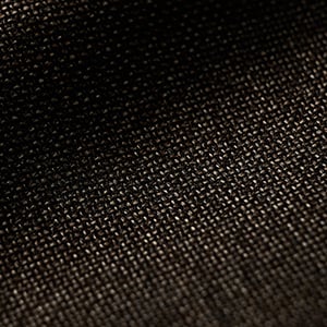 Close-up of a dark brown woven fabric with a fine, tight weave texture and soft light across the surface