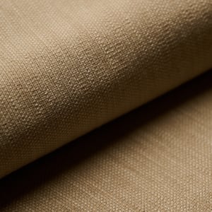 Close-up of a beige woven fabric with a fine texture, folded to show soft shadows between the layers