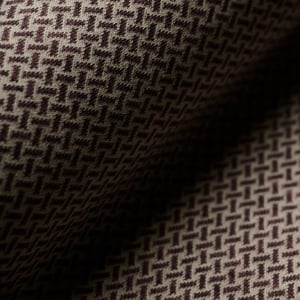 Close-up of a draped wool fabric with a small brown and beige geometric basketweave pattern