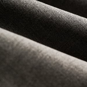 Close-up of soft folds of dark grey woven wool fabric with a fine, textured weave