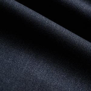Close-up of dark navy wool fabric with a fine woven texture, softly draped in gentle folds