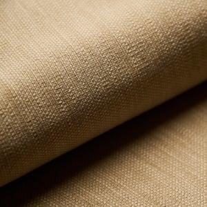 Close-up of a beige fabric with a fine woven texture, draped in soft folds