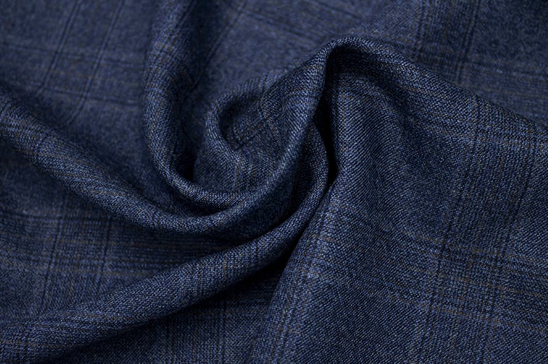 Navy blue wool fabric with a subtle check pattern, draped in a soft swirl