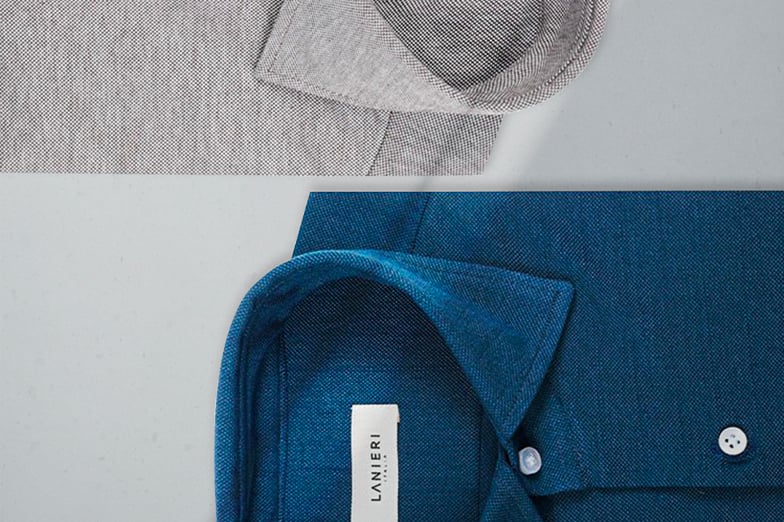 Folded blue and gray shirts with open collars; the blue one has a white Lanieri Italia label