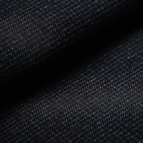 Close-up of dark navy wool fabric with a fine woven texture and soft folds