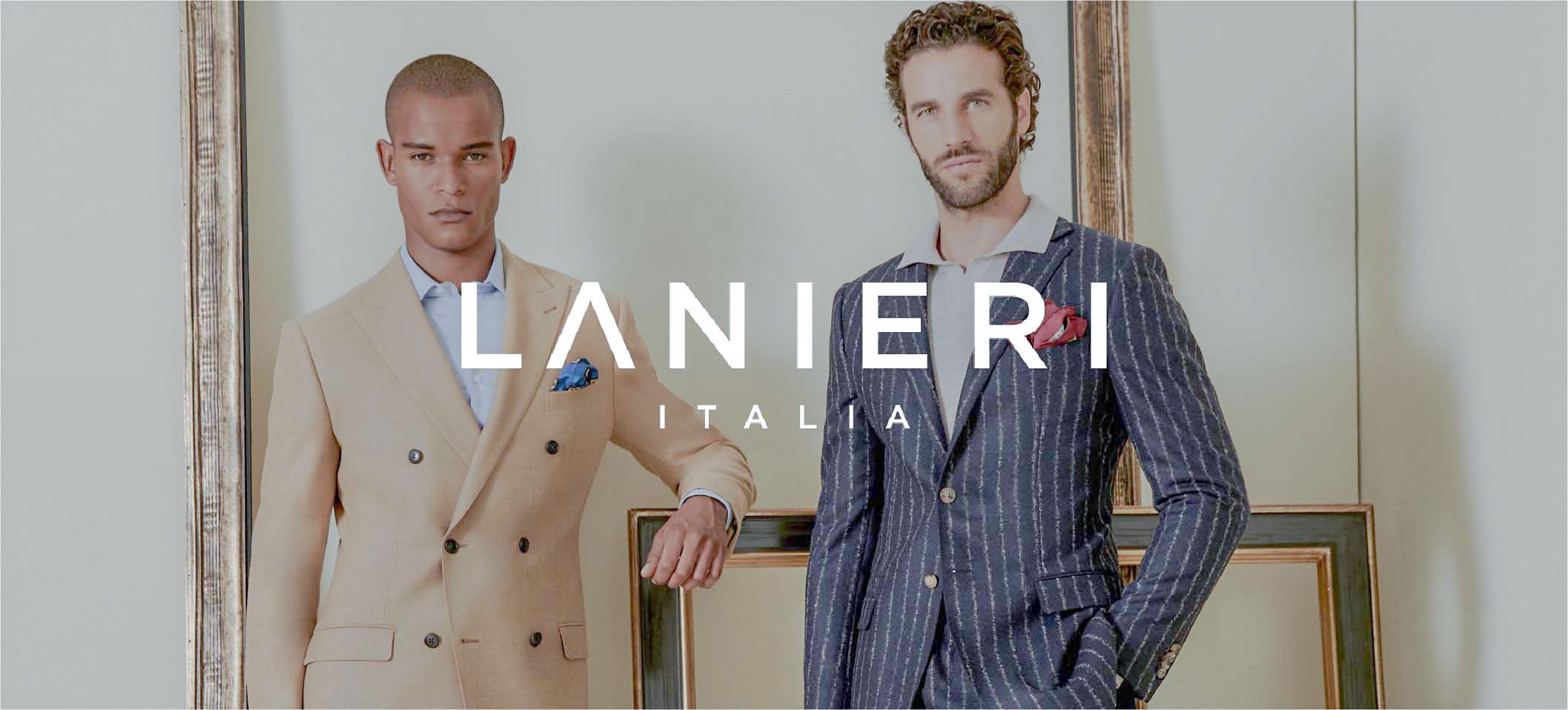 Two men in tailored suits, one beige double-breasted, one navy pinstripe, under the Lanieri Italia logo