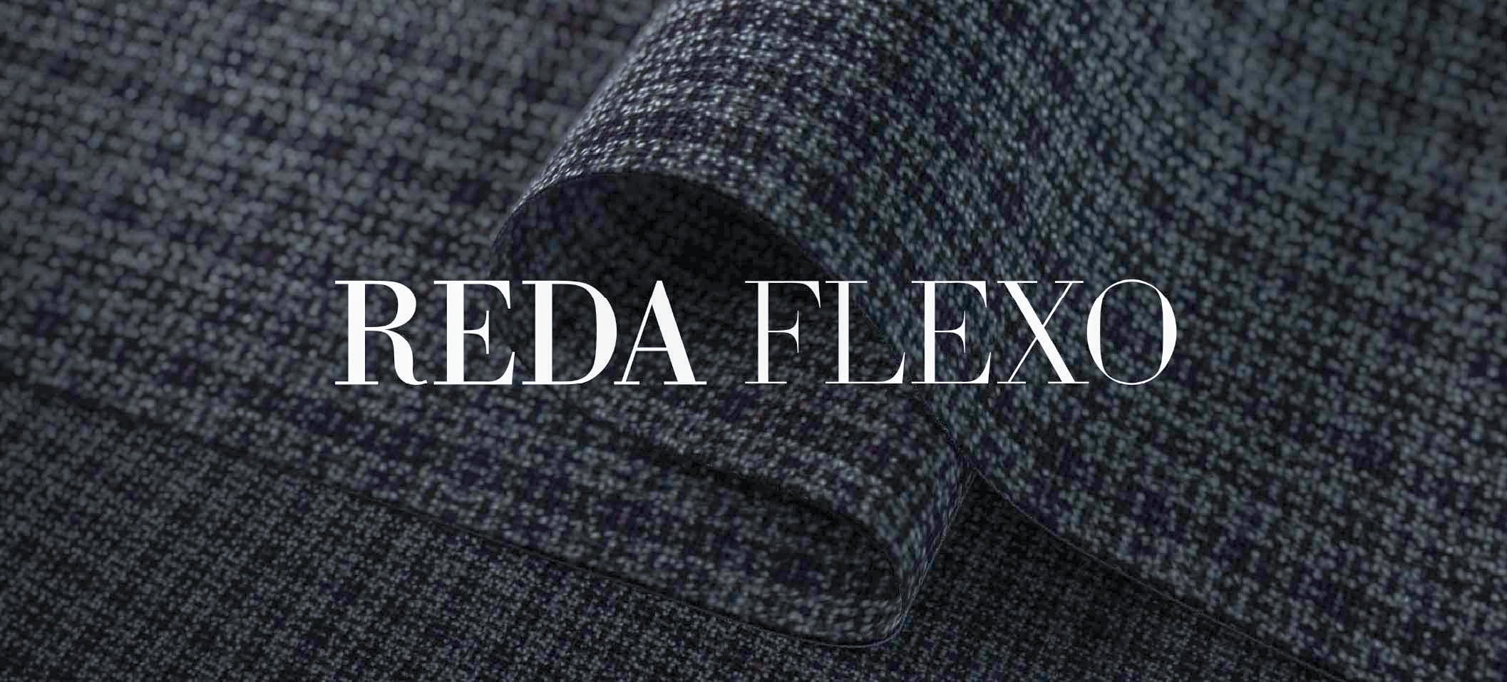 Folded dark blue-grey woven wool fabric with the text "REDA FLEXO" overlaid