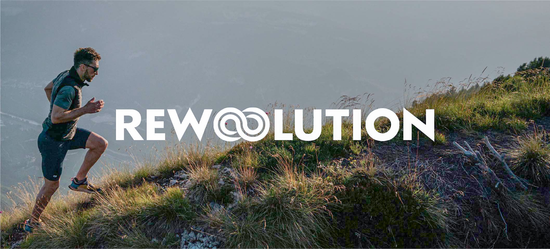 REWOOLUTION logo over a man trail running uphill on a grassy mountain ridge