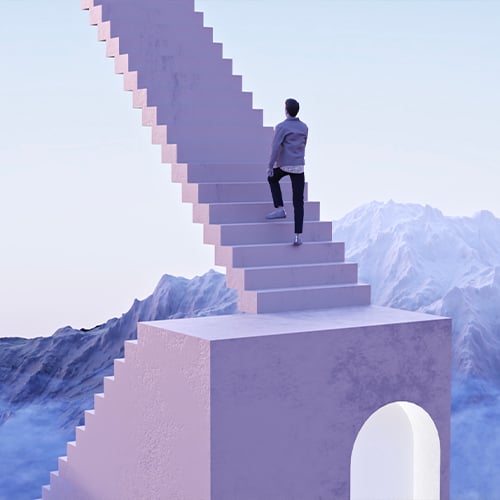 Man in a jacket climbs a long lilac staircase rising from a block with an arched opening, among mountains