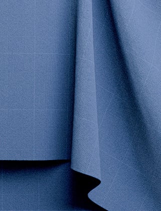 Blue woolen fabric with a subtle check pattern, draped in soft folds against a flat panel of the same cloth