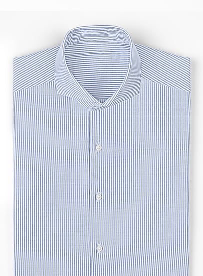 Folded blue and white striped shirt with a cutaway collar and white buttons on a light background