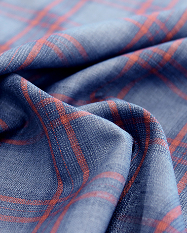 Draped blue wool fabric with an orange-red and navy windowpane check pattern