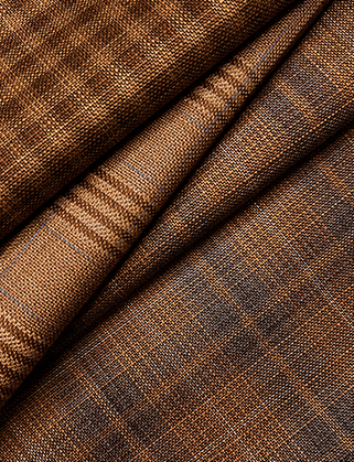 Folded brown and tan woolen fabric with a subtle woven check pattern and blue-gray accents