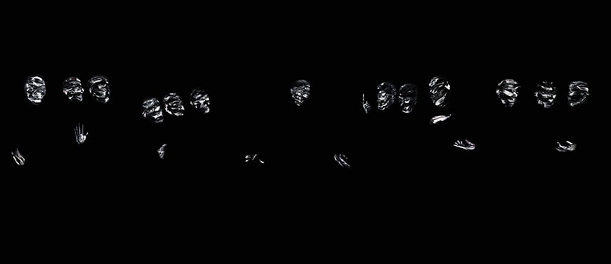 Groups of pale, textured masks and hands glowing against a black background, arranged in a horizontal row